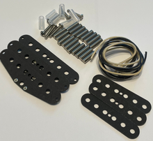 Load image into Gallery viewer, A guitar hardware and strap adjuster kit laid out on a white surface, including black metal plates, silver screws, washers, and a coil of black and beige wire.